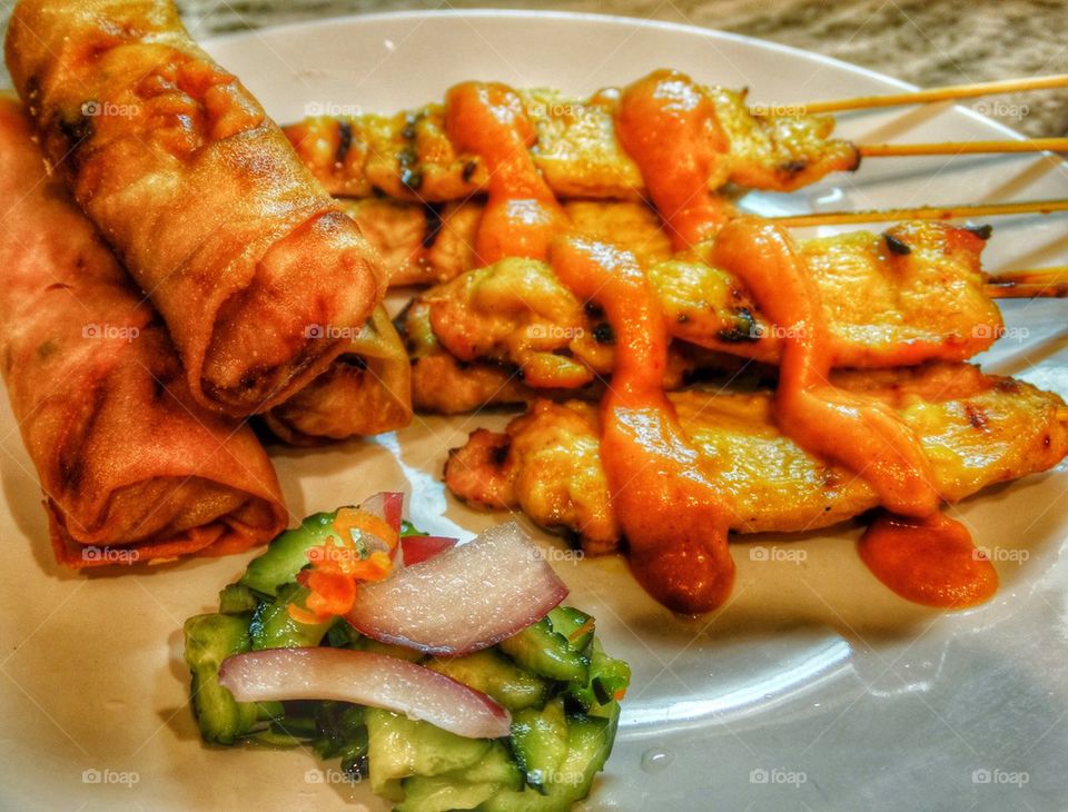 Variety Of Thai Food Appetizers. Thai Satay Chicken And Spring Rolls
