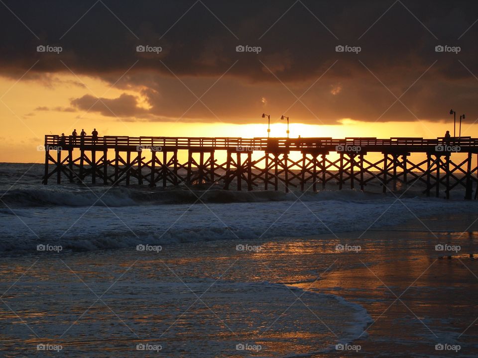 Sunset and Rain. Rain and Sun is a good mix at Florida. View of the pier from one of most beautiful beaches in United States at Destin! 