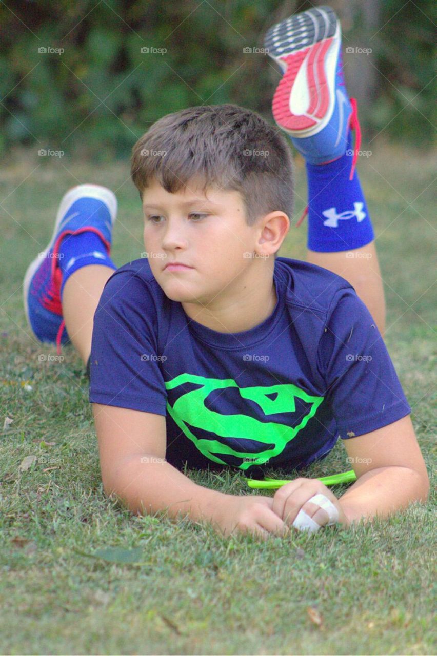 Handsome boy lying on grass