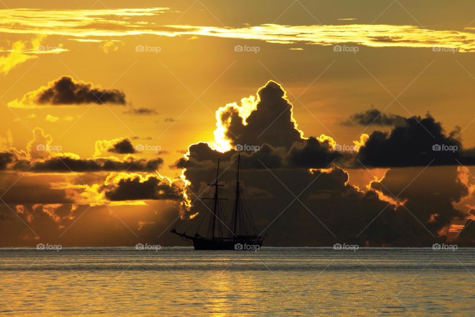Nautical vessel in sea during sunset