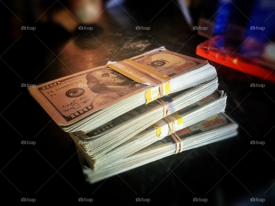 Image of a pile of money, hundred dollar bills in stacks of 10k per stack. Total of 40k bucks