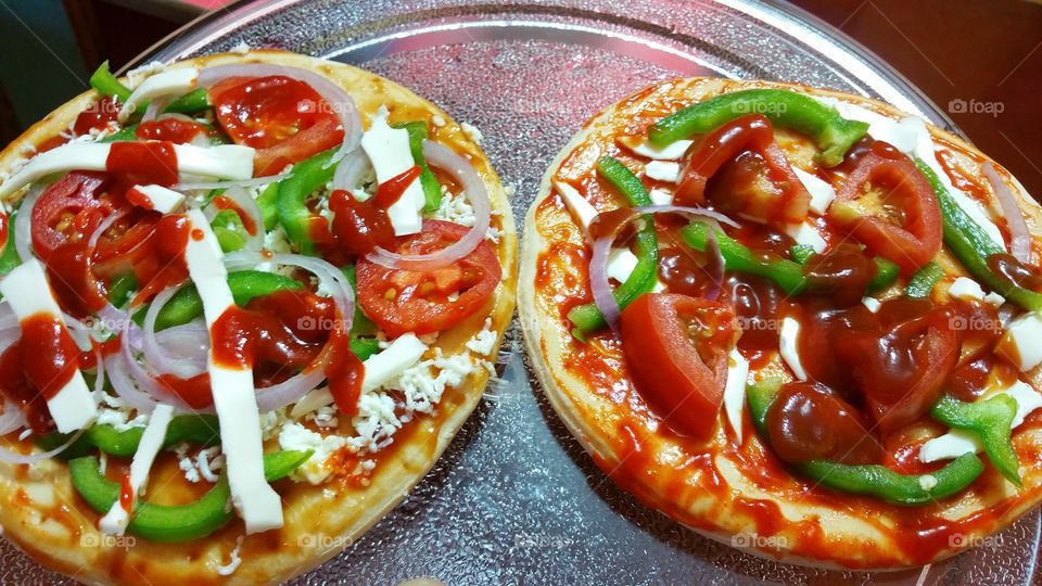 two pizzas close up cheese capsicum