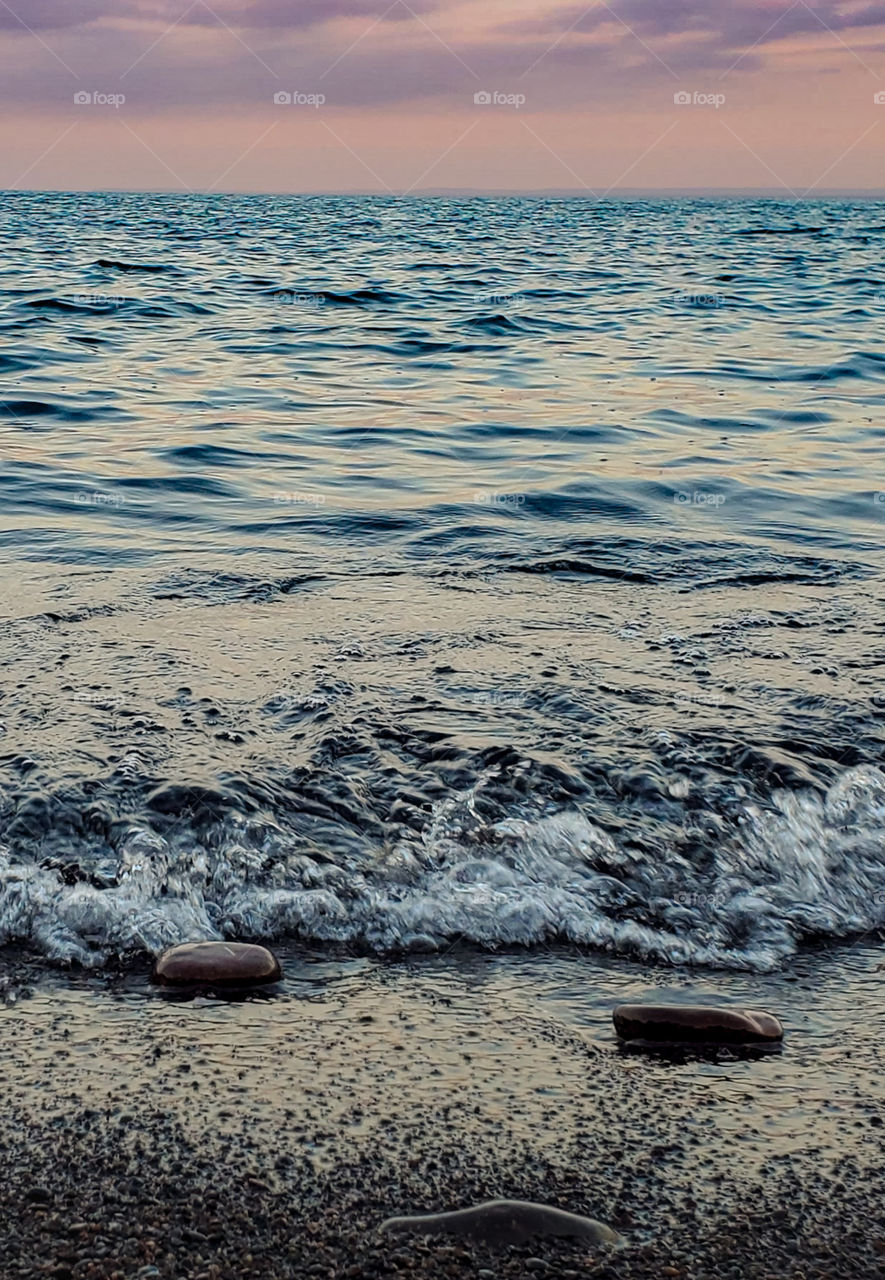 Lake Superior shoreline view of the sunset.  Relaxing to the waves.