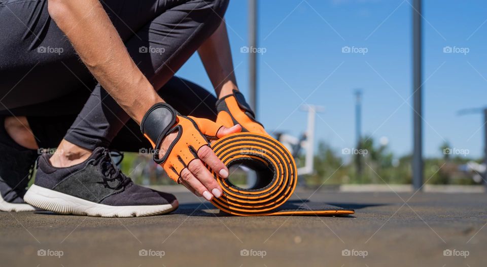 woman rolling training mat