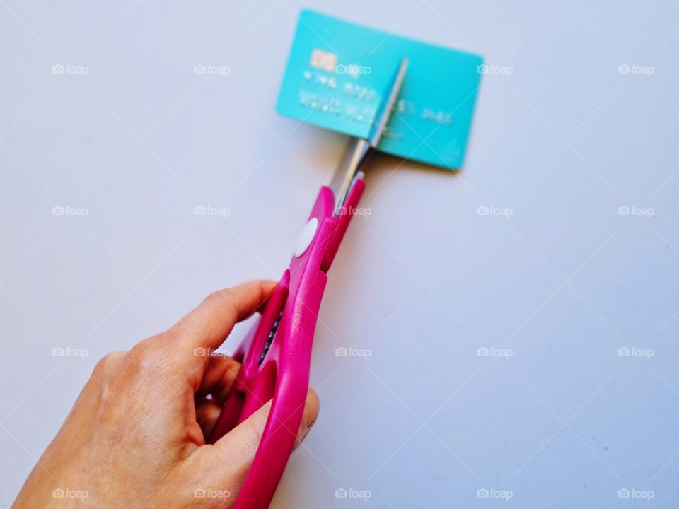 hand on scissors cutting credit card