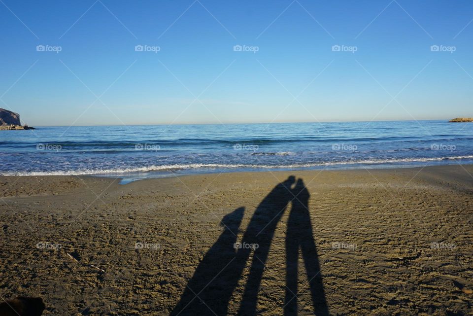 Beach#shadow#silhouette#humans#dog#sea