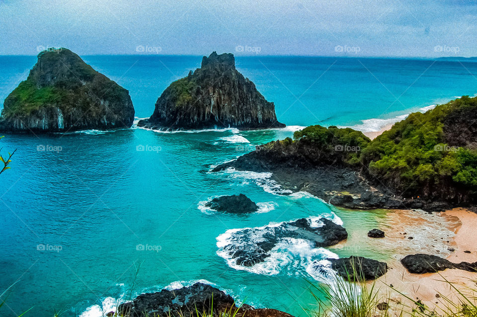 Two rocks in the sea . Waterfront panoramic view. Fernando de Noronha island. Brazil 
