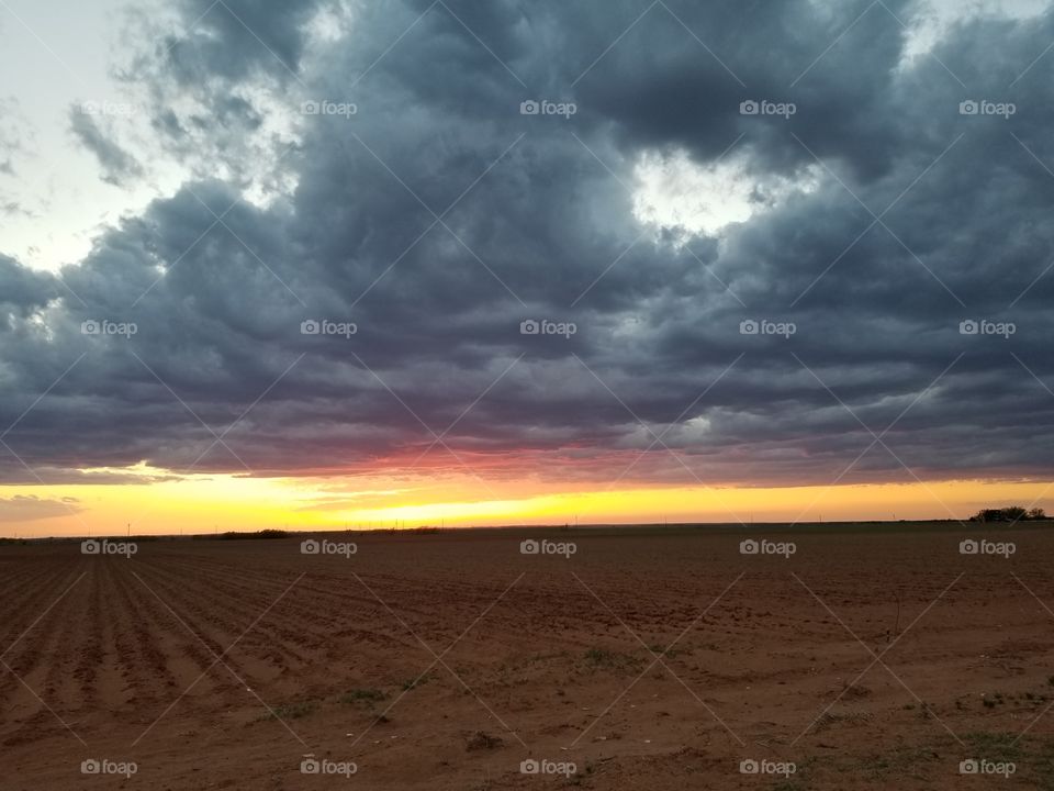 sunset with a storm rolling in rural Texas
