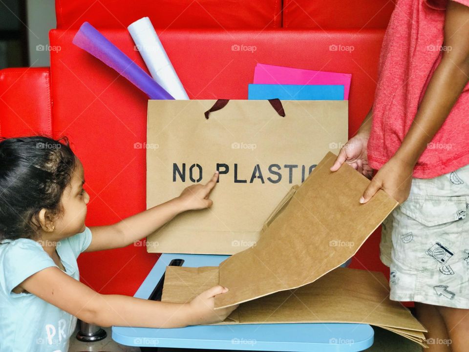 Kids encouraged to use and carry paper bags instead of carrying plastic bags.here two kids discussing about use of paper bags and how it impacts on nature and earth.