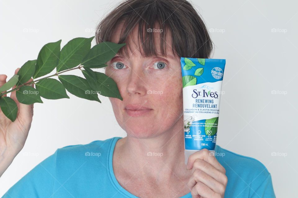 Woman with St.St.Ives skon care product on hand