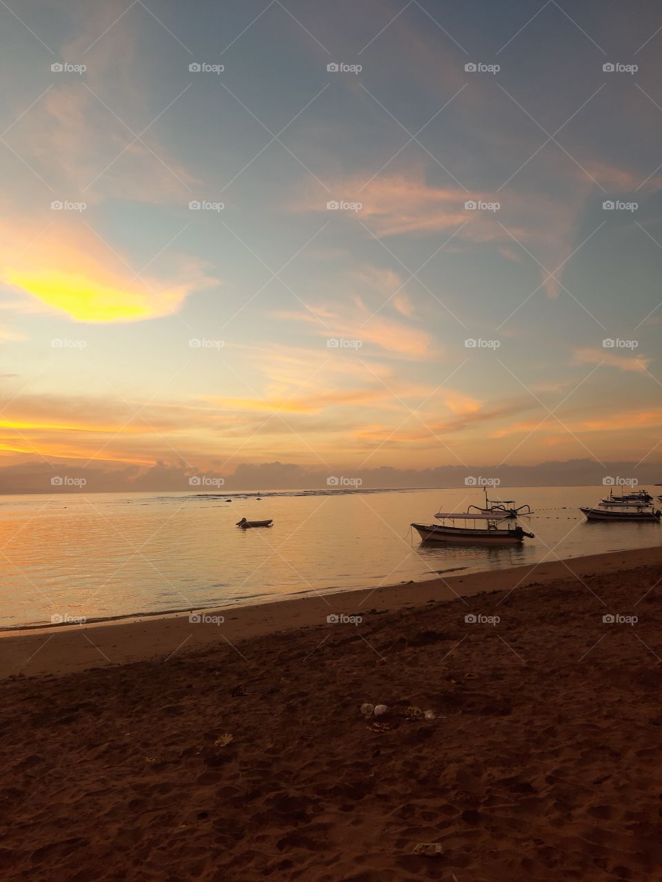 Beautiful view of sunrise on the white sand beach in Indonesia