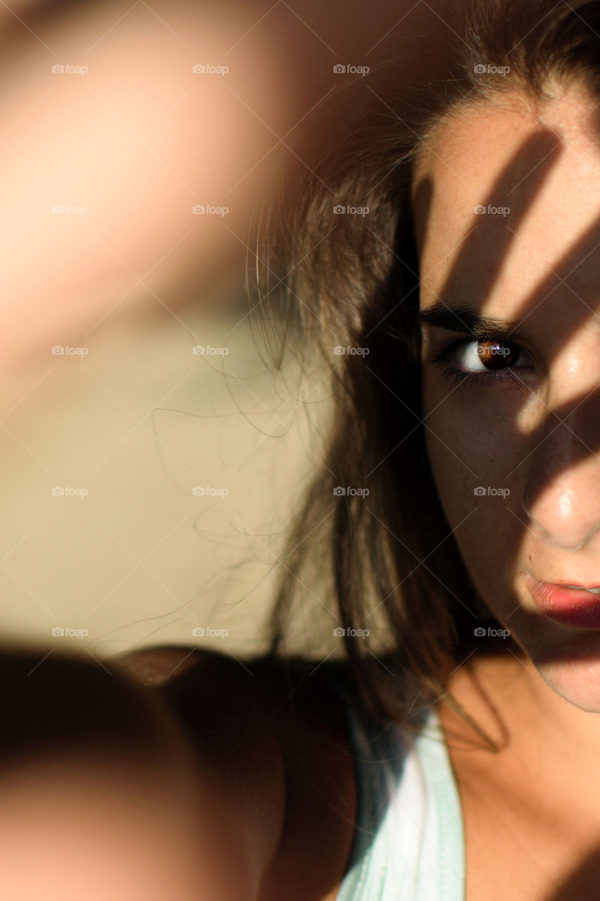 Portrait of girl covering her face from the sun light