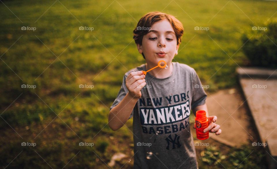 Boy blowing bubbles