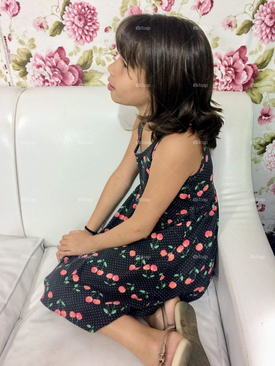 child sitting in white armchair