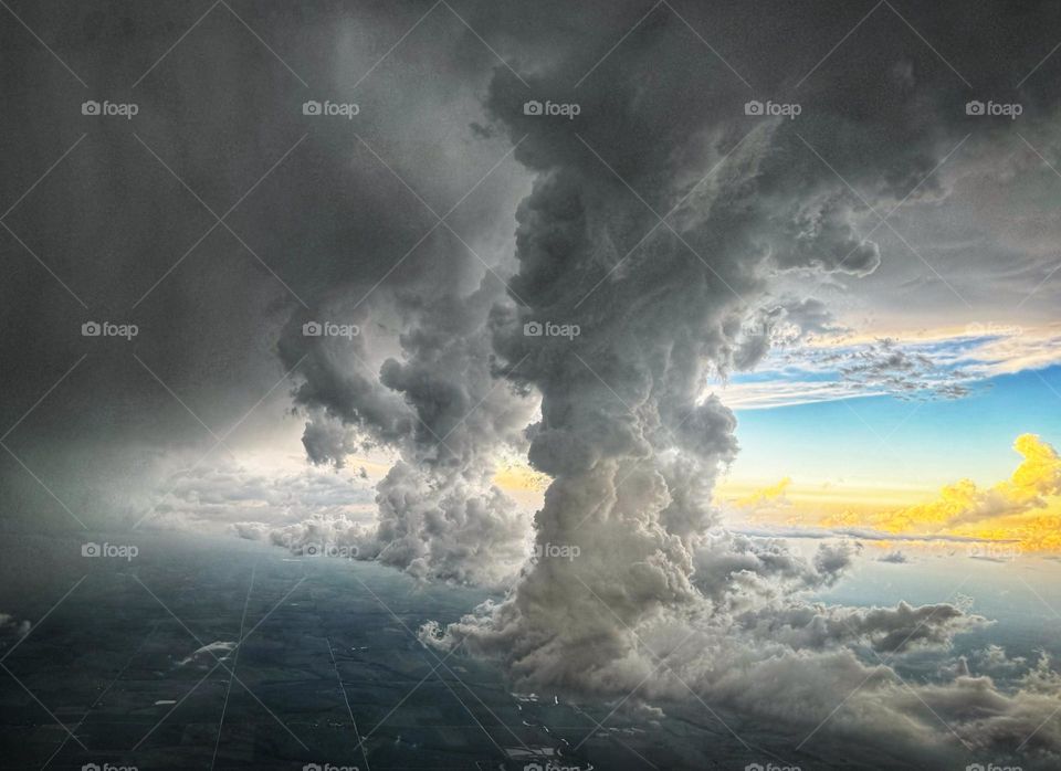 Two rising thundercloud columns ahead of an approaching storm