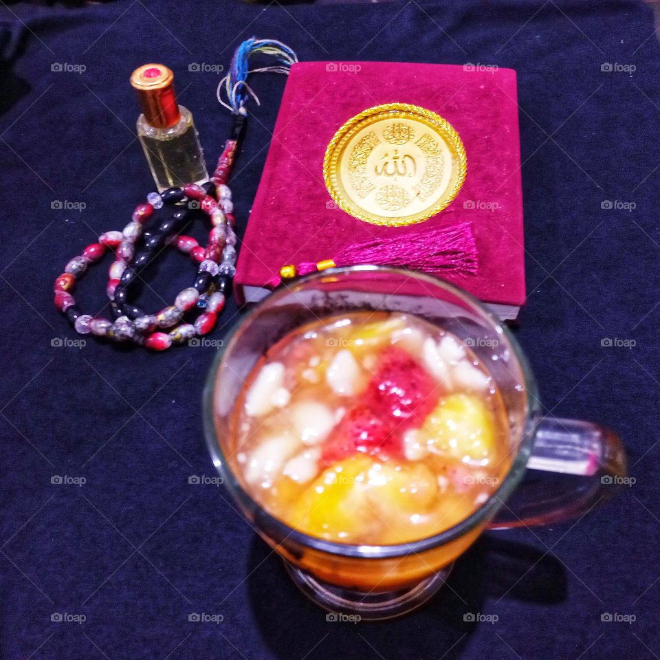 A glass of fruit drink (dinghy) for starters and fragrant prayer beads and the Holy Bible