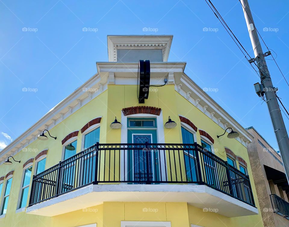 European style architectural top of commercial and historical yellow charming building from balcony.