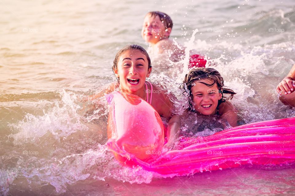 Brother and sisters enjoying in sea