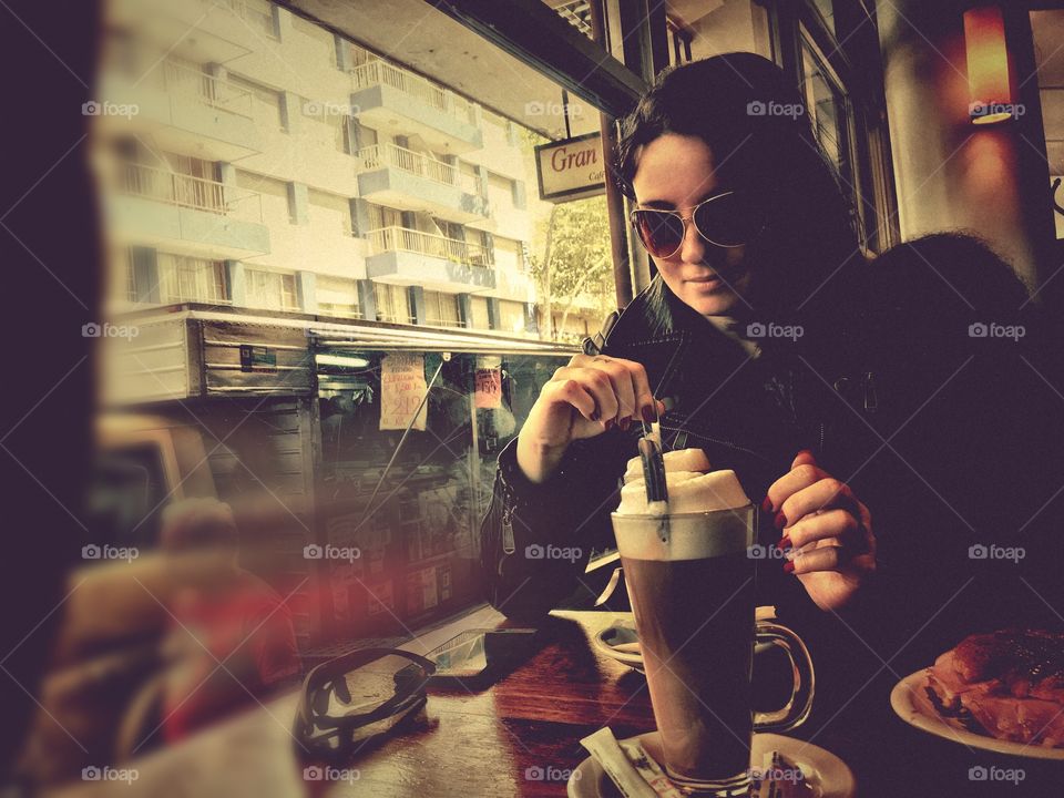 Attractive woman drinking coffee in café