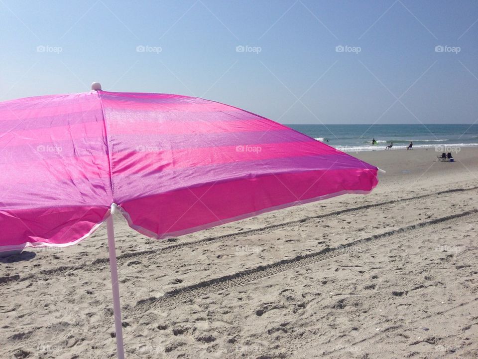 Pretty pink umbrella on the beach