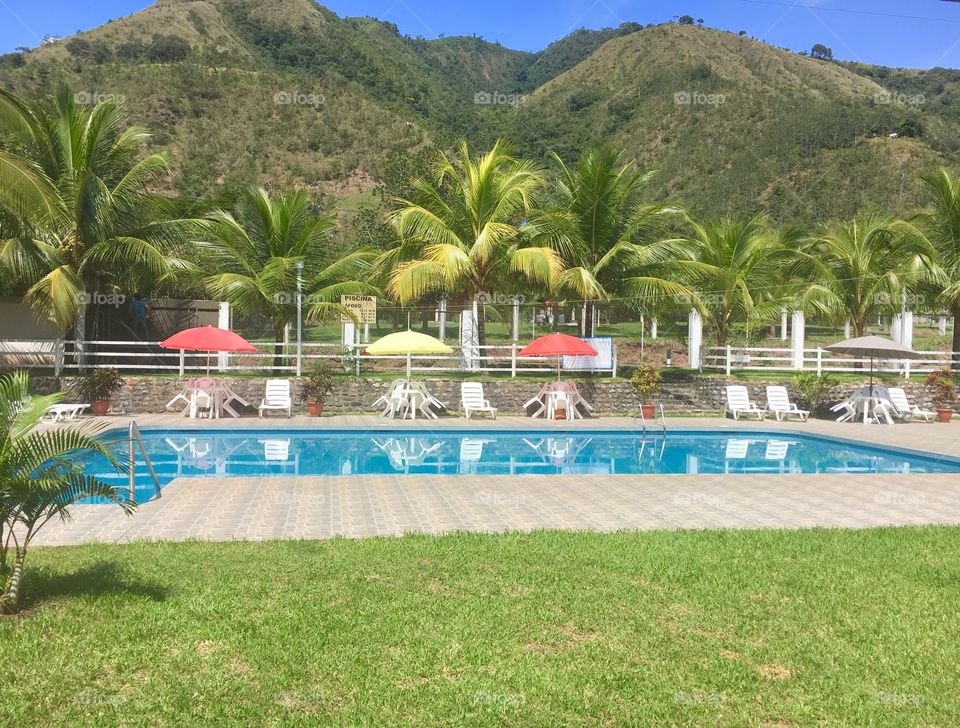 beautiful resort pool with lush mountains and beautiful blue sky at tranquil resort outside La Merced Peru
