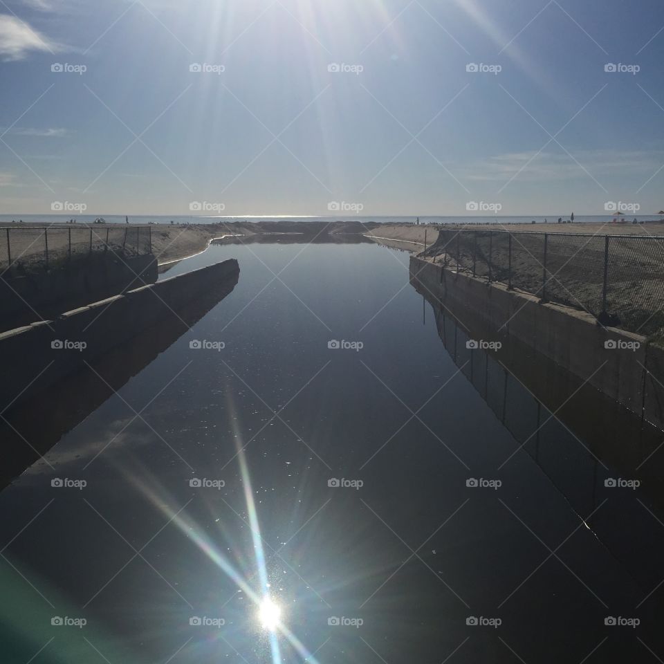 Waterway on Venice Beach. A manmade waterway on Venice Beach, CA that may be used for draining purposes during storms. Nice sun reflection. 