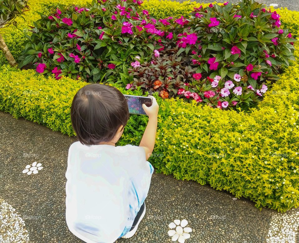 handsome asian boys stand in front of various design plants