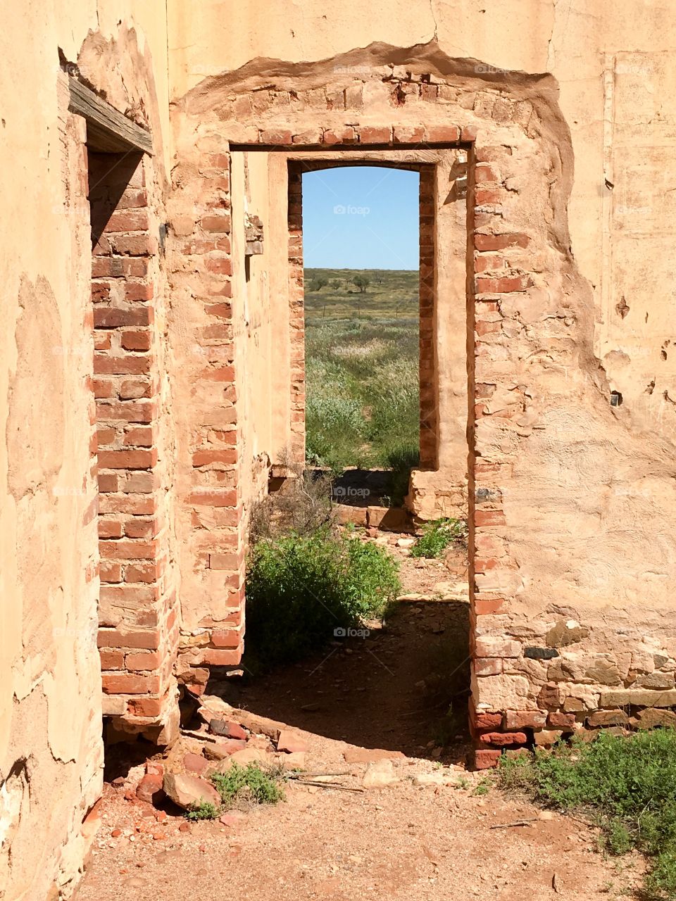 Abandoned brick and mortar house, portal doorway symbolising decisions and destiny