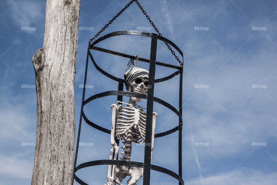 Hanging skeleton in the cage