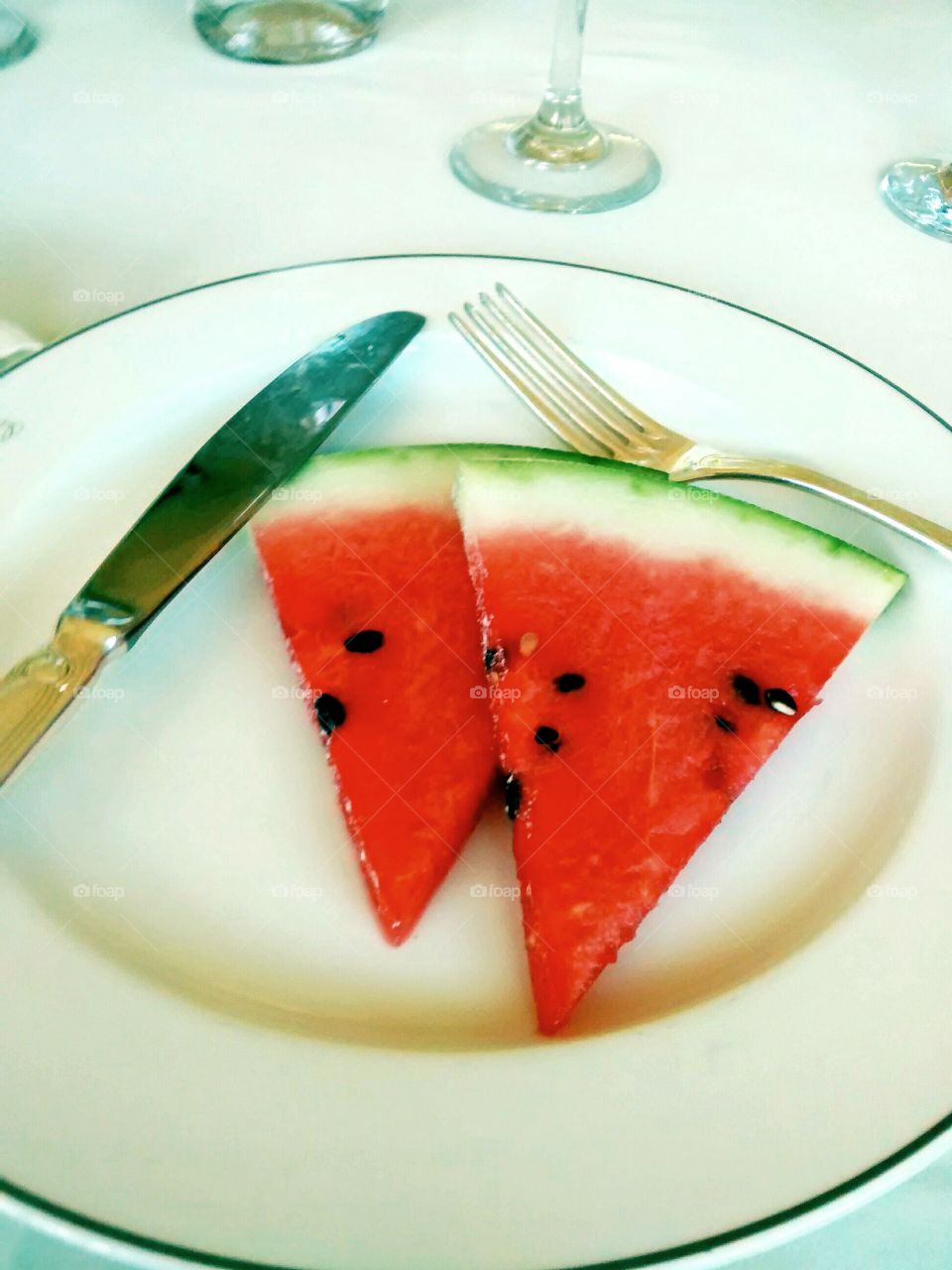 Watermelon luxury. delicious watermelon slices in a luxurious restaurant ... the silver cutlery stand pure freshness of seasonal fruits