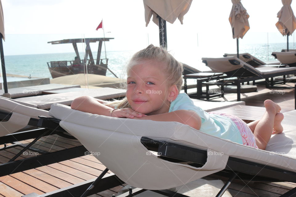 Blond girl relaxing on the beach 