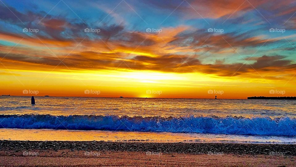 Dramatic sky over sea at sunset