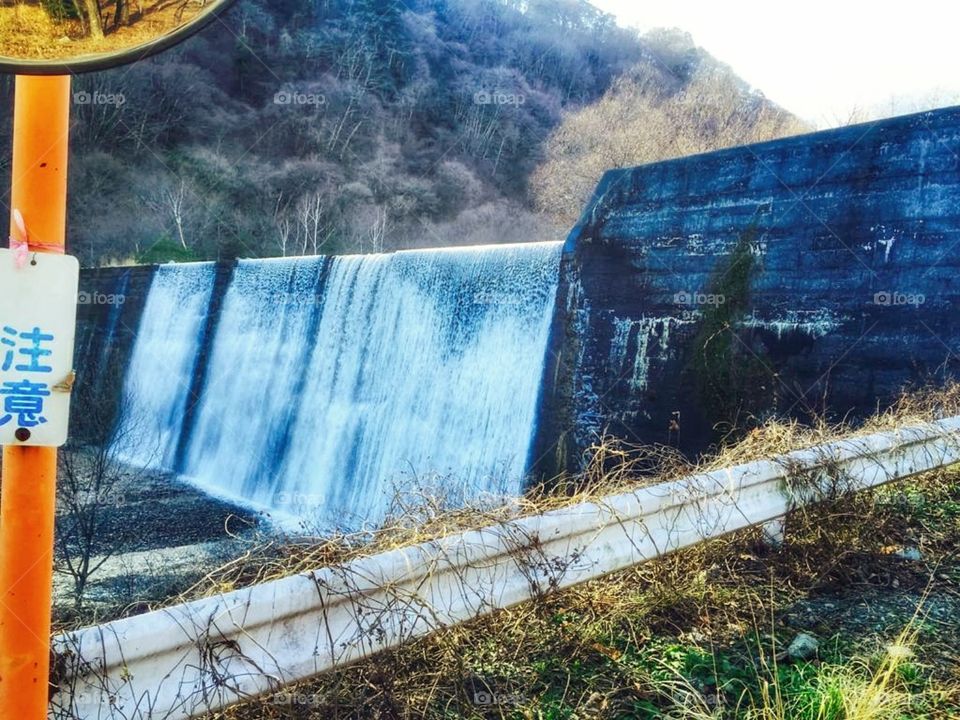 amazing waterfall in dam morning view