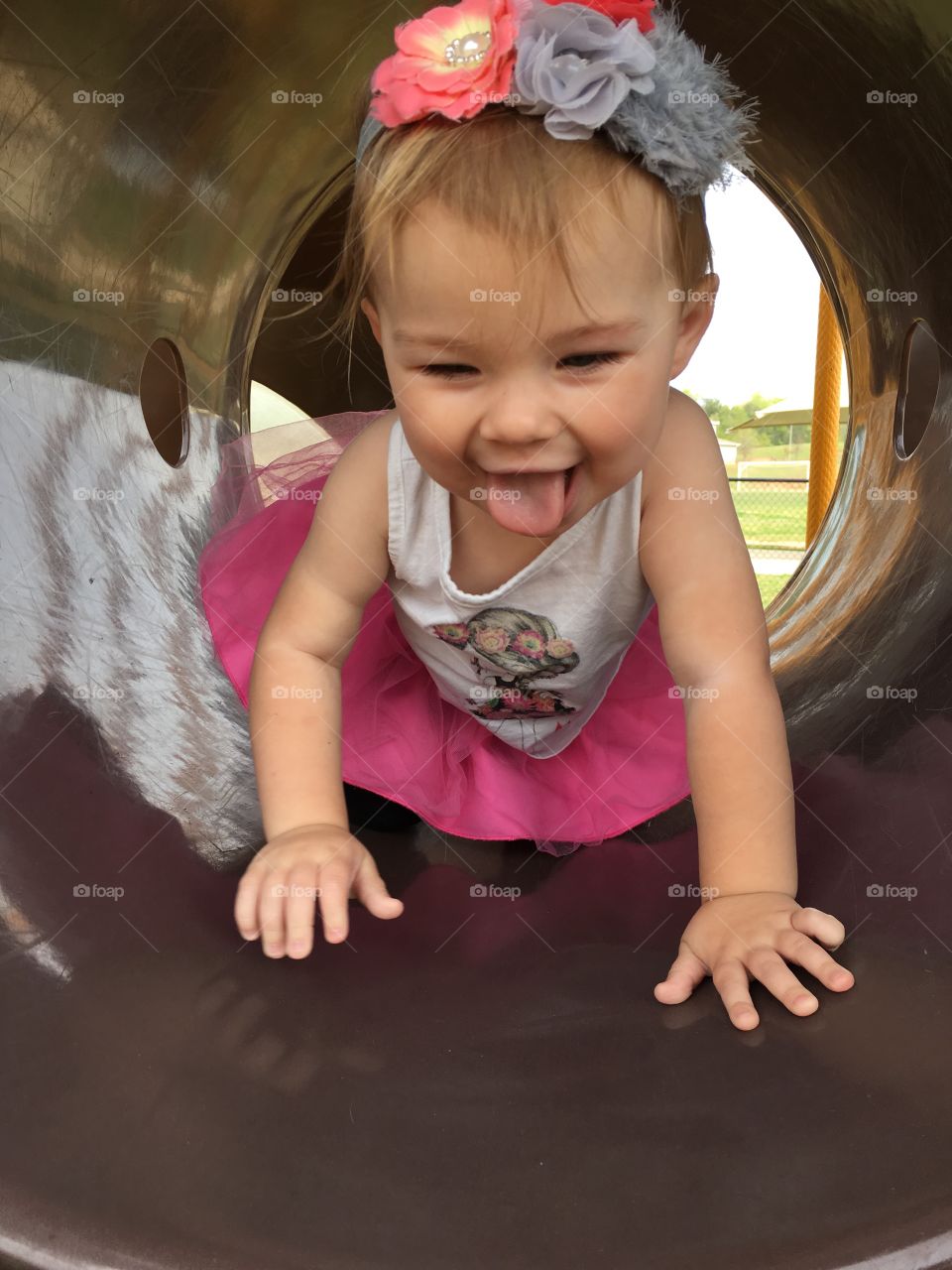 Cute girl crawling in cave at park