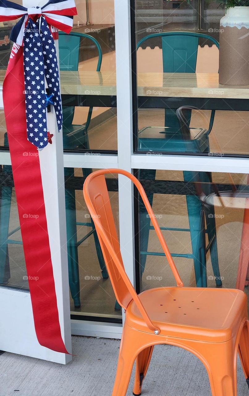 patriotic red, white, and blue ribbon proudly displayed on door of frozen yogurt shop in Oregon for Independence Day