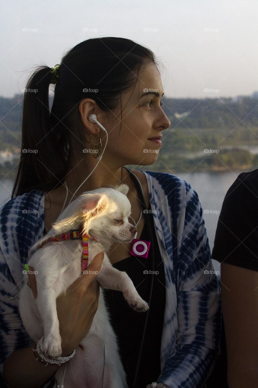 Profile of young woman with white dog