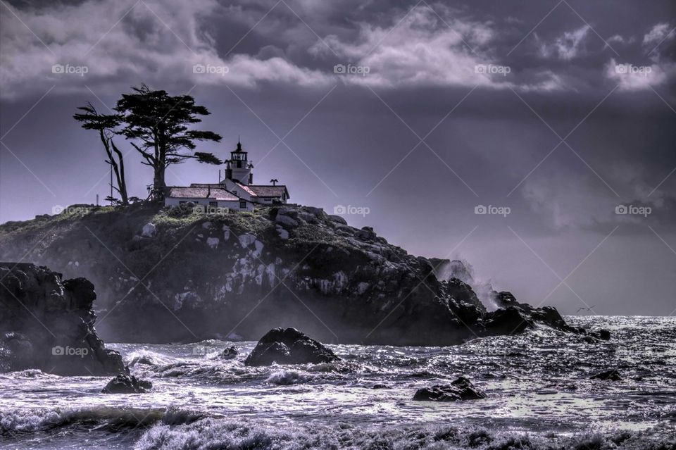 Lighthouse on cliff near sea