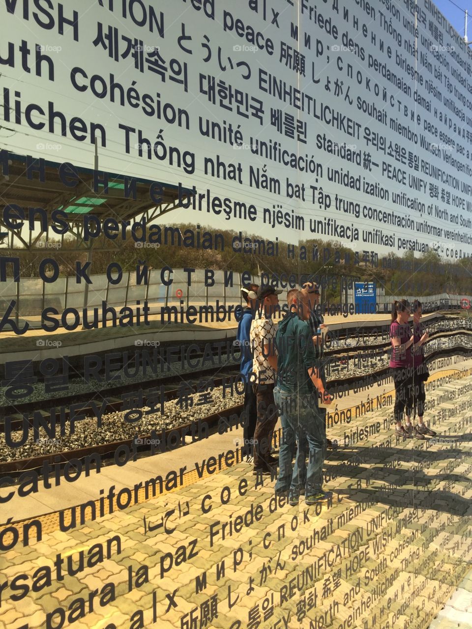 'Unification' 

Located at Dorasan Station, the last train station before North Korea. This wall is inscribed with the word 'Unify' in different languages. It's placed before a piece of the Berlin Wall. 