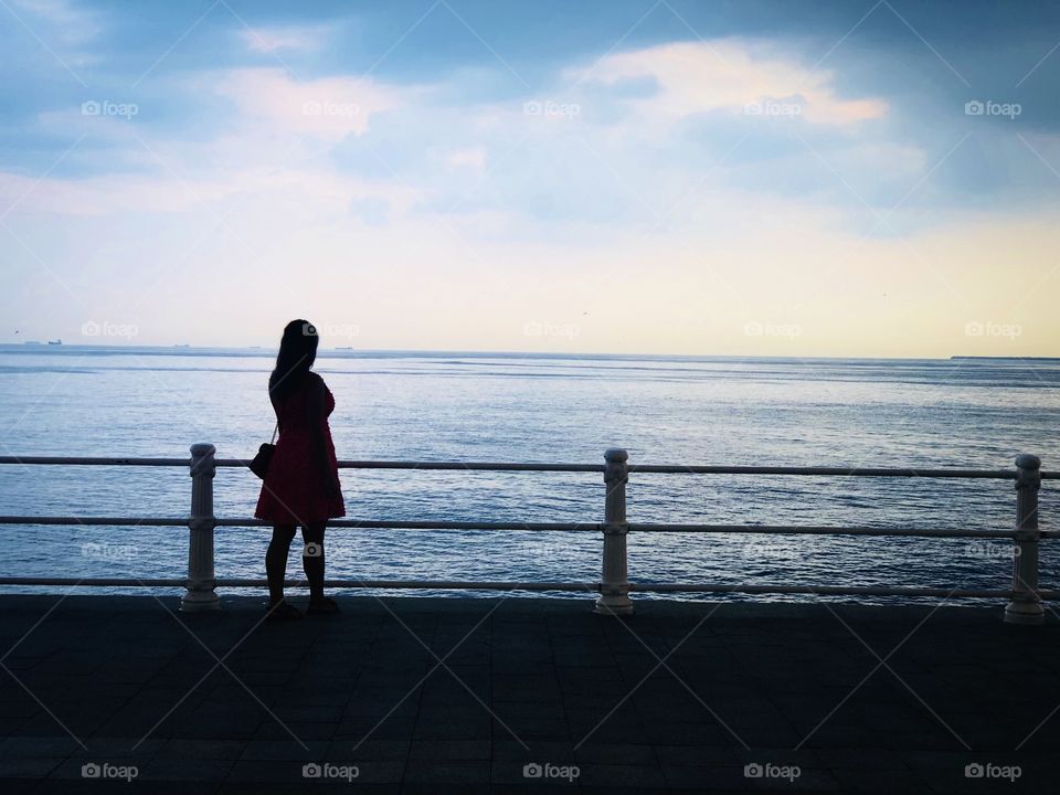 Silhouette of woman on the pier