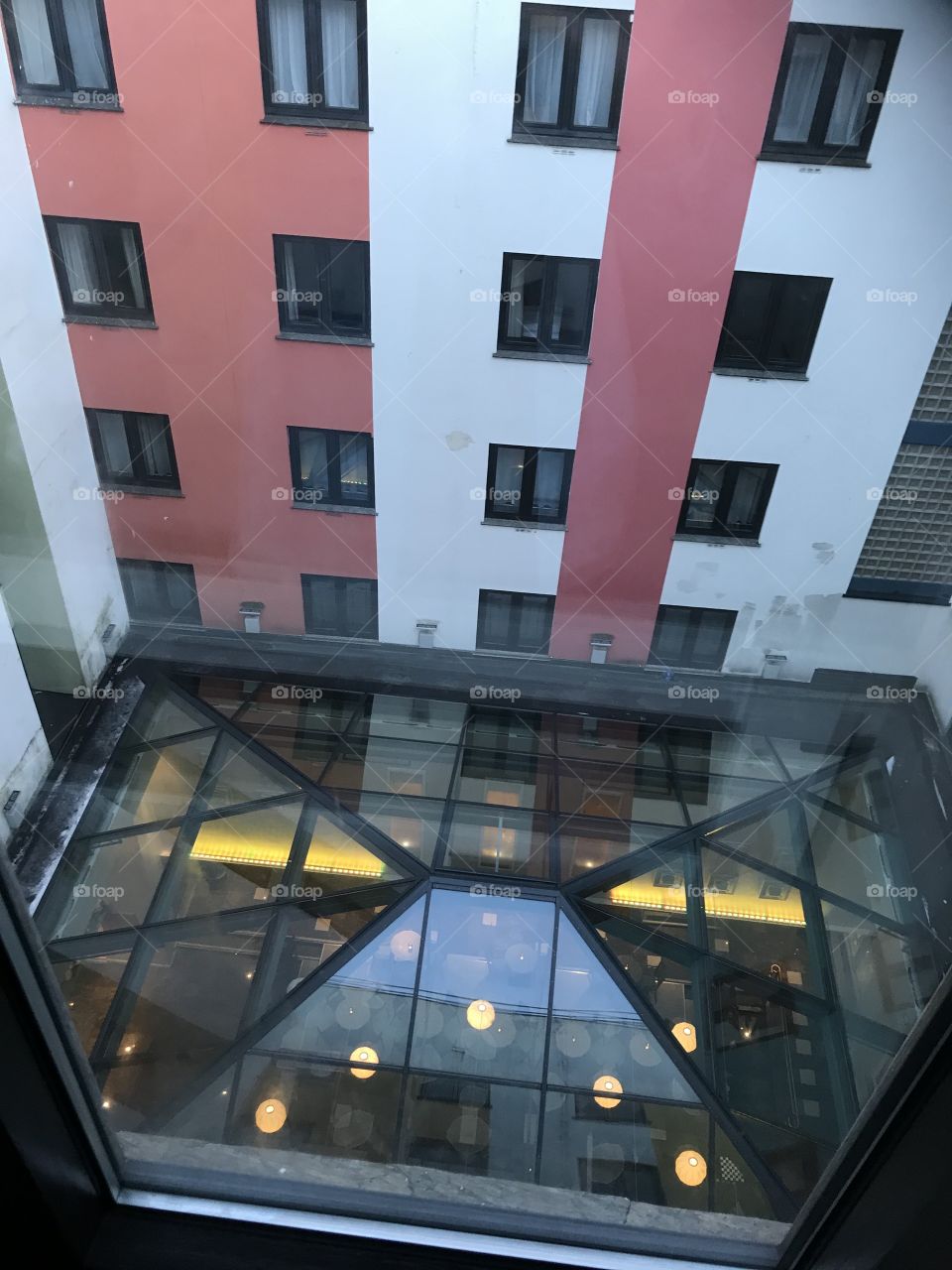 Roof top inside of a hotel in Bergen. Red and white squared walls surround the roof.