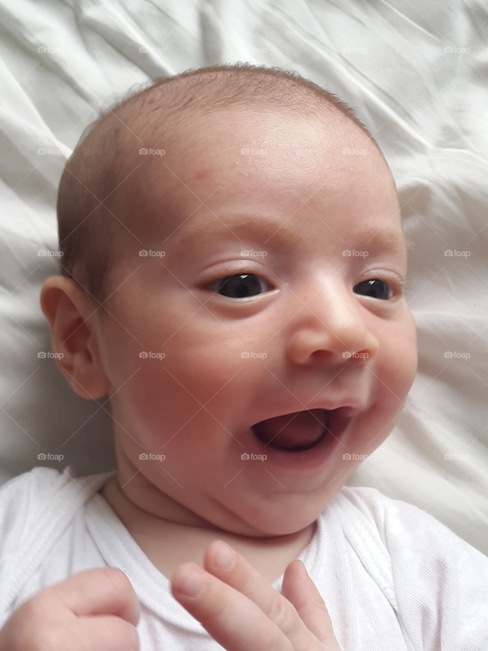 High angle view of baby resting on bed