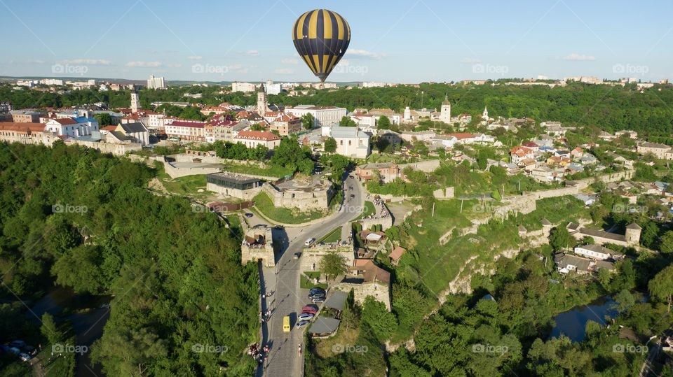 Hot air balloon under the old european city