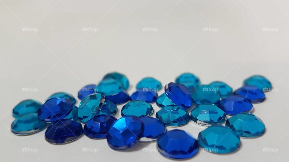 Blue beads over white background