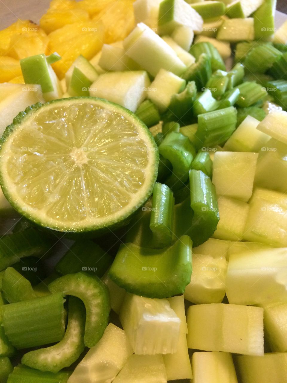 Fresh fruit and vegetables. Prepping to make a green smoothie with lime, pineapple, celery and cucumber