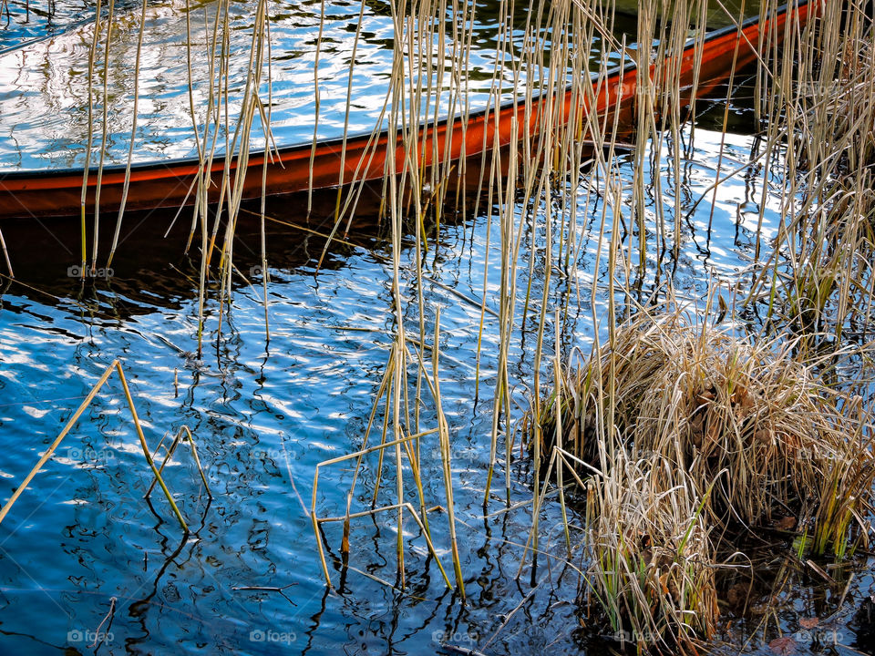 Boat filled with water in Bagsværd Lake, Denmark.