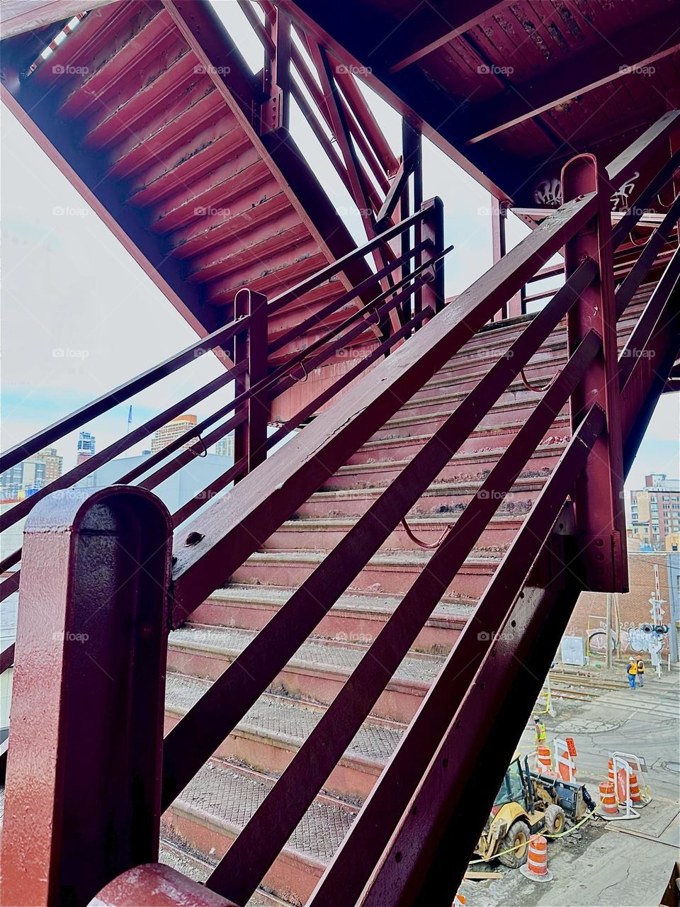 This is the red metal staircase of the “Pulaski Bridge” at “Newtown Creek” that connects LIC to “Greenpoint”, Brooklyn. The style of this industrial modern architecture reminds of the “Bauhaus” school of the 1930s. 2024. Hypnotic Productions