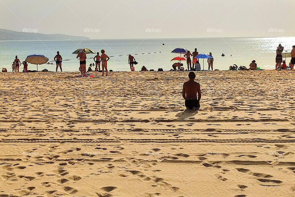 Man Meditating Yoga on the Beach