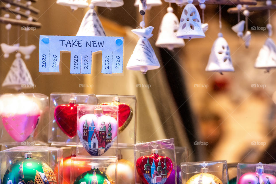 Christmas shop window with paper with the phrase: Take New and with a 2020 sign ready to be tore off