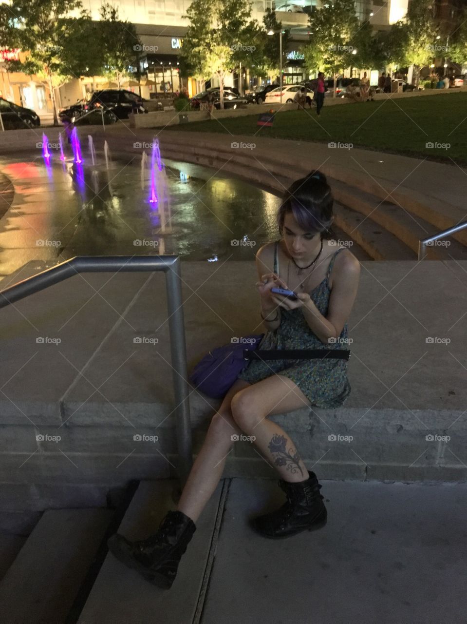 Young woman texting in city