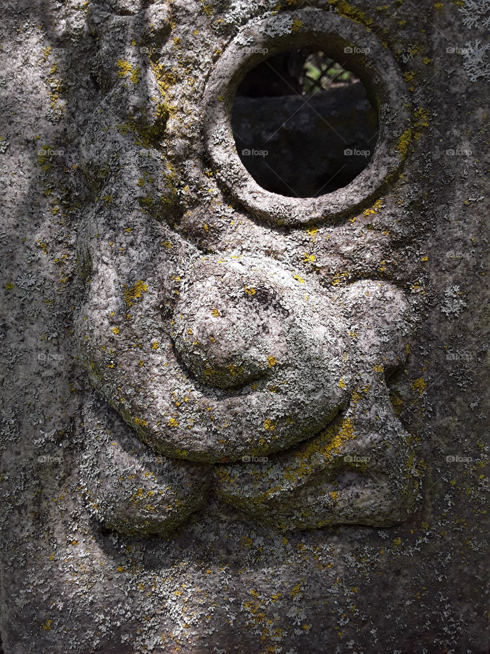 Weathered stone sculpture with a hole in it